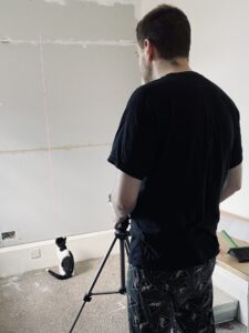 Jim Setting up the Laser Level to put up wallpaper